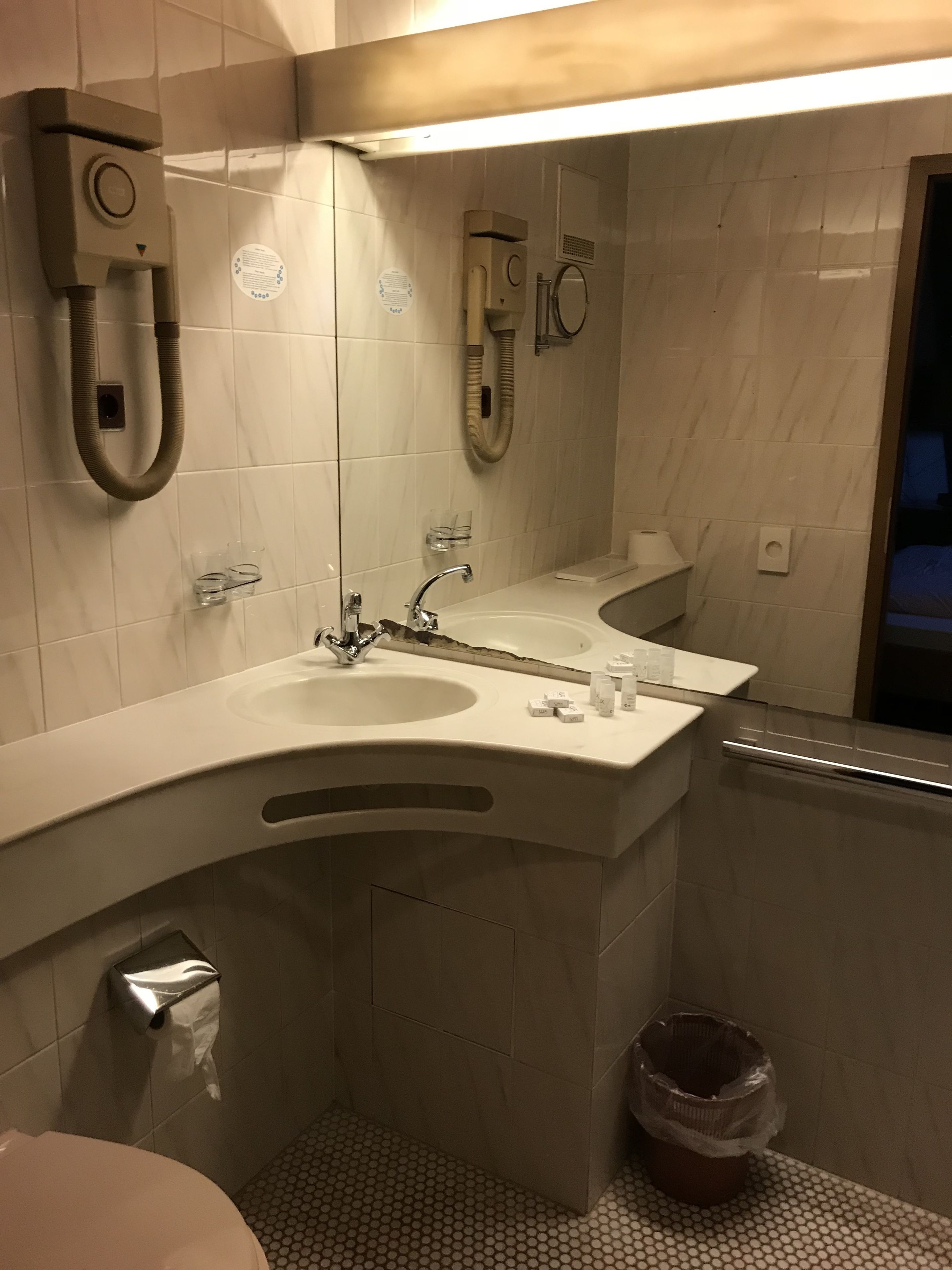 Un bagno moderno con due lavandini, un WC e una doccia.