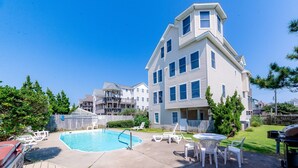 A residential building with a swimming pool, outdoor seating, and a barbecue area. - Cloud Nine - KDH MP 7, Semi-Oceanfront, Ocean View, 120 Yds to Beach, Pool, Hot Tub, Pets OK (Kill Devil Hills)