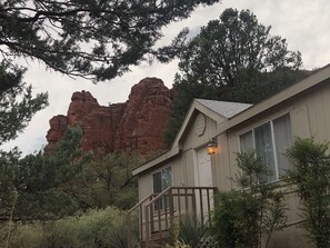 Escape to a rustic retreat surrounded by nature, with a cabin-style hotel nestled among a picturesque red rock formation.