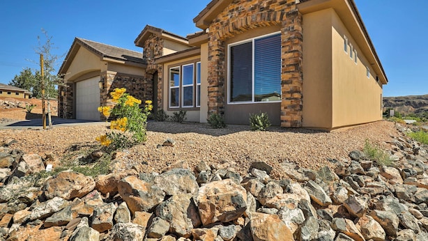 A modern house with a stone facade, large windows, and a well-maintained garden. - La Verkin Home w/ Hot Tub, Kayaks, & Bikes! (La Verkin)