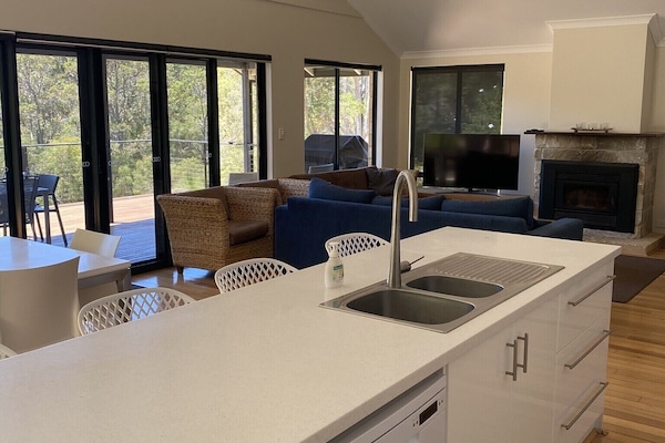 Open plan kitchen, dining room and family room opening onto north facing deck.