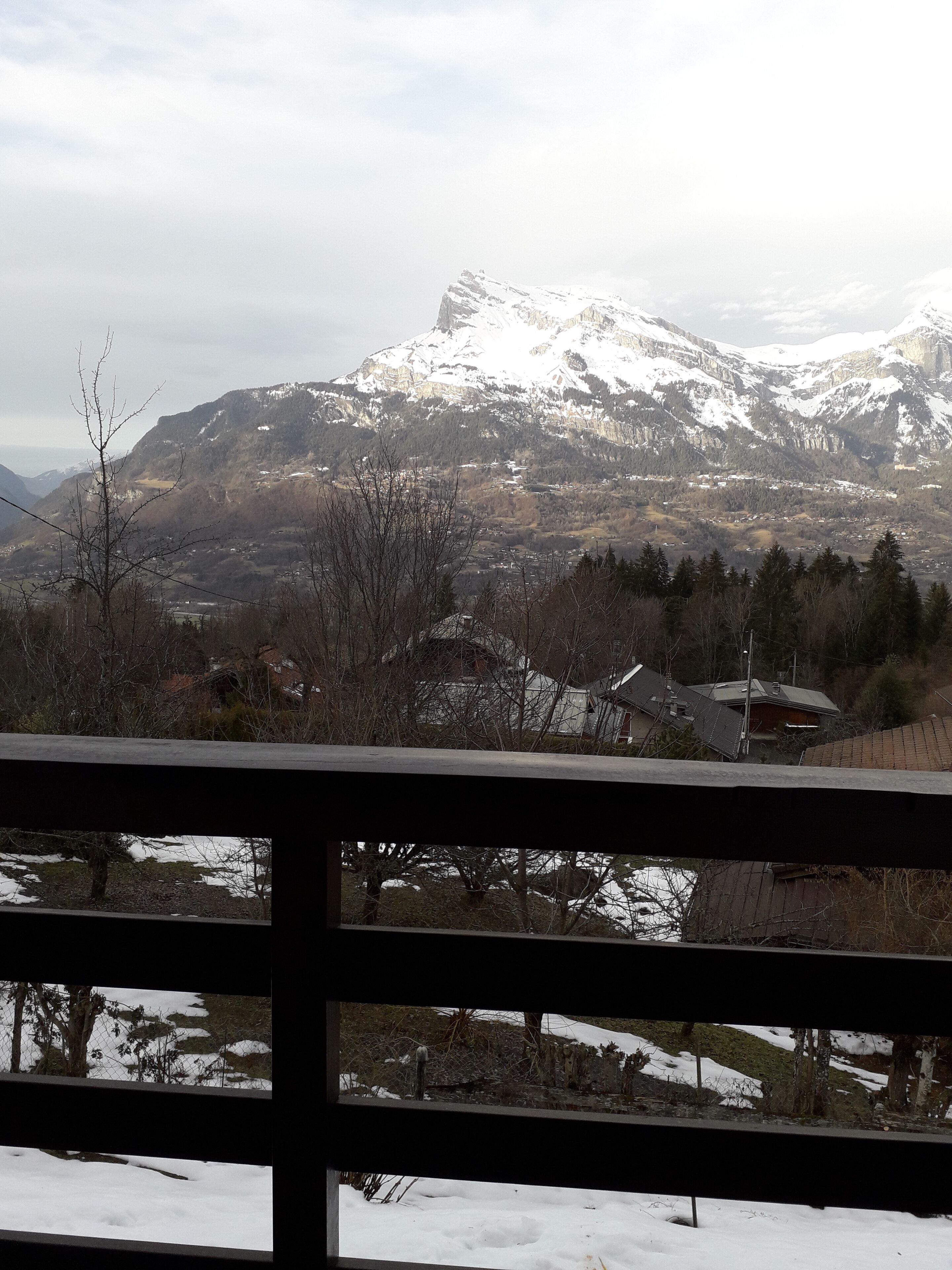 A mountainous landscape with snow-covered peaks and a valley below.