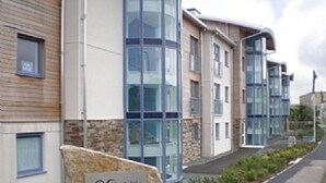 A modern building with a stone facade and large glass windows. - Magnificent Sea views, Central, 2 double bedrooms, 2 bathroom. Pets welcome.   (Newquay)