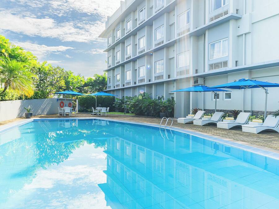 Outdoor pool, open 7:00 AM to 9:00 PM, pool umbrellas, sun loungers