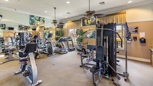 A gym with various exercise equipment, including treadmills, stationary bikes, and weight machines.