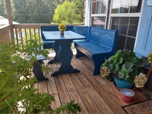 A wooden deck with a blue bench and table, surrounded by potted plants and a red bucket. - BEAUTIFUL PLACE! NEW POOL Relaxing, Peaceful, Meticulous Cleaned. Firepit, Grill (Alpine)