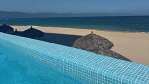 A swimming pool with a view of the beach and ocean. - Peninsula Vallarta-Luxurious/Huge Oceanfront Condo w/ Spectacular View (Puerto Vallarta)