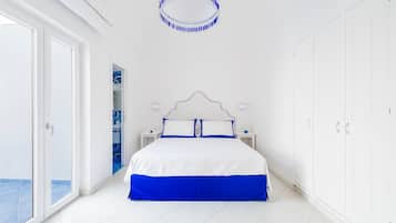 A bedroom with a bed, a wardrobe, a nightstand, and a circular ceiling light.