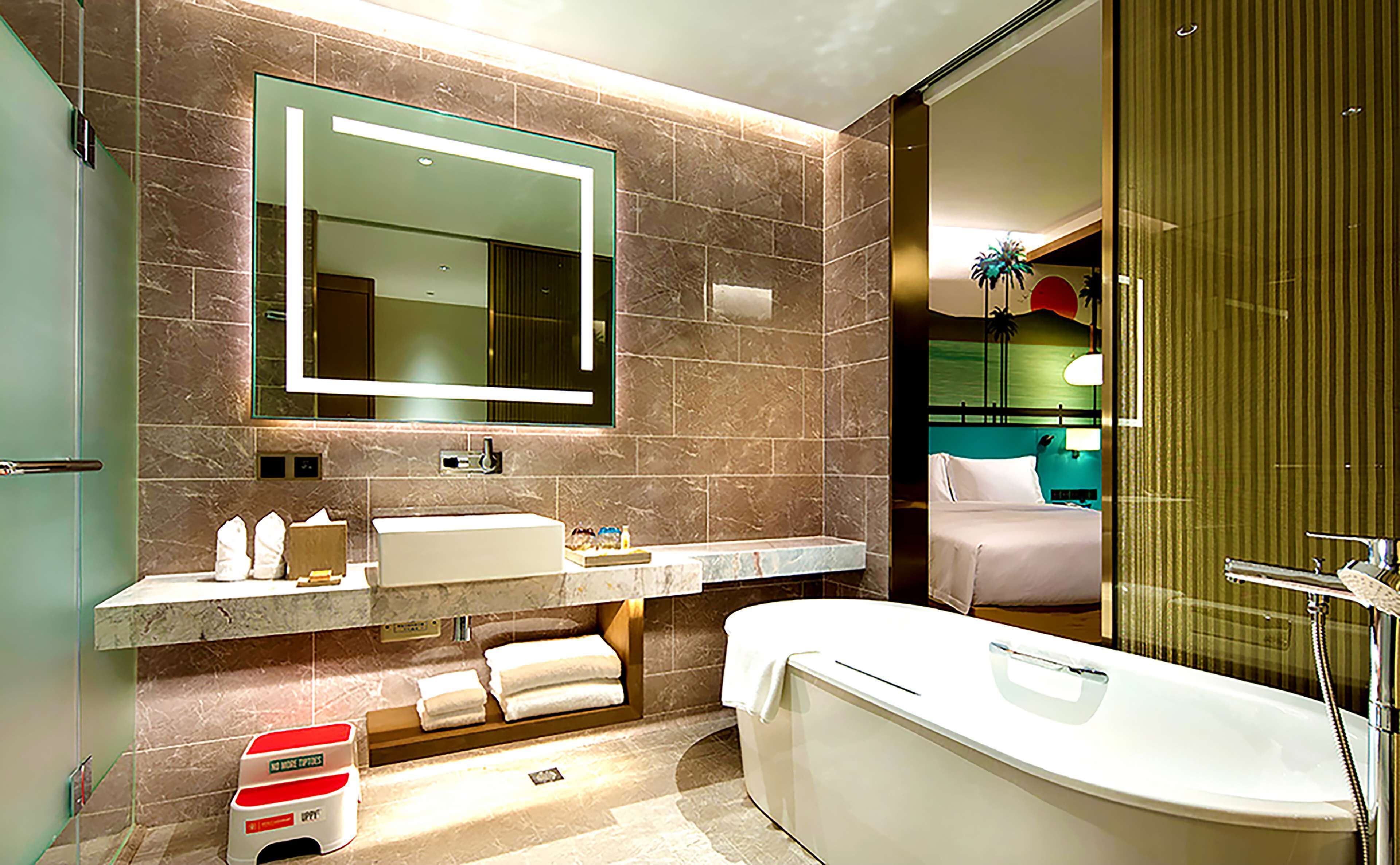 family room, 1 king bed, balcony, sea view | bathroom | combined shower/bathtub, hair dryer, bathrobes, slippers