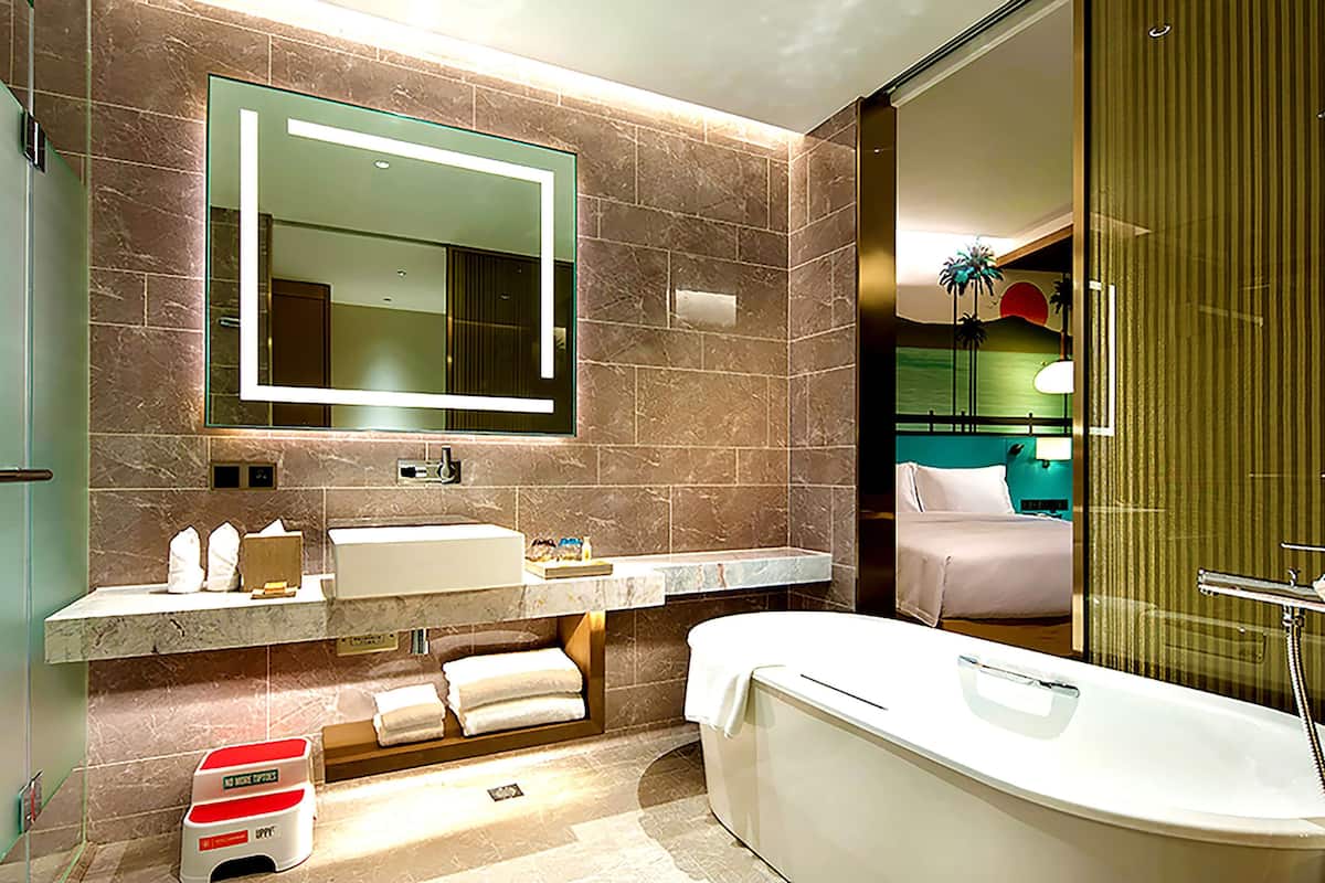 family room, 1 king bed, balcony, sea view | bathroom | combined shower/bathtub, hair dryer, bathrobes, slippers