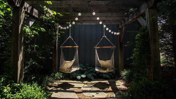 A wooden pergola with two hanging hammocks and string lights. - The Barn at Strasburg B&B (Strasburg)