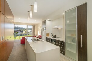 Apartment 43, Two bedroom and a “sleep out” plus Two bathrooms | Private kitchen | Full-size fridge, microwave, oven, stovetop