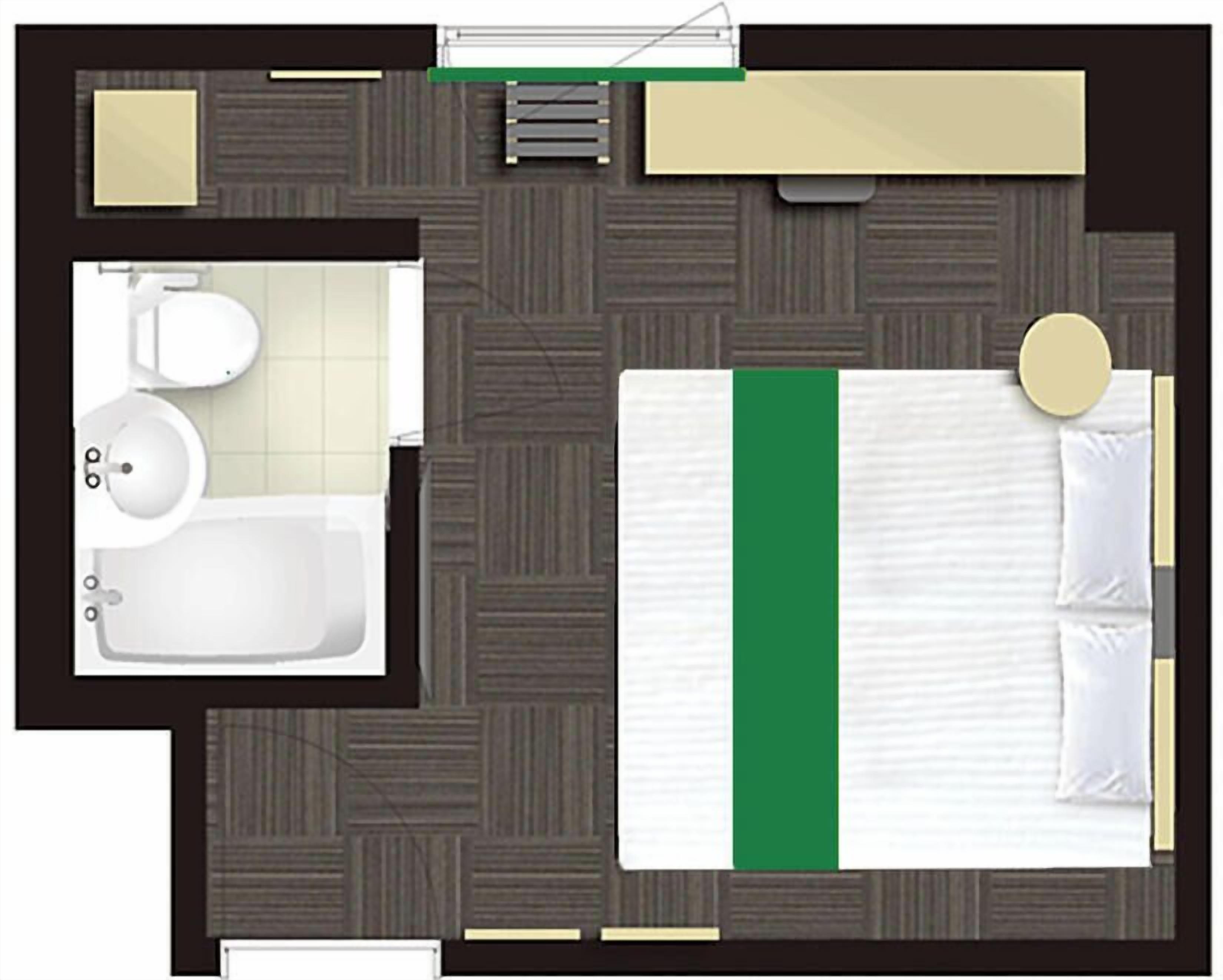 Et hotelværelse med seng, badeværelse med toilet og håndvask samt en lille siddeplads.