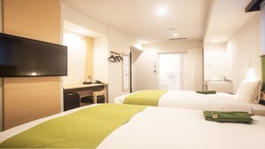 A hotel room with two beds, a desk, a TV, and a bathroom visible through an open door. - Hotel Kuretakesou Hiroshima Otemachi (Hiroshima)