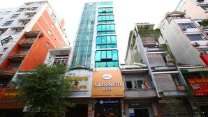 A hotel with a modern glass facade, a prominent orange sign, and multiple balconies. - Saigonciti Hotel (Ho Chi Minh City)