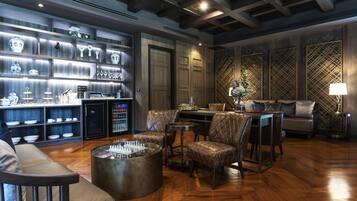 A modern interior with a bar area, seating, and a decorative wall.