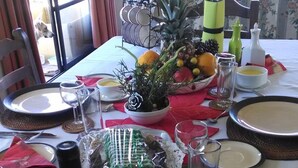 A dining table set for a meal with various dishes, including a bowl of soup, a plate with a green salad, and a wrapped item. - B&B Rocas Santo Domingo (Santo Domingo)