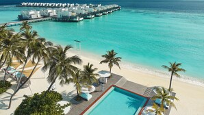 A resort with overwater bungalows, a swimming pool, and a beach area. - Jumeirah Olhahali Island  (Olhahali)