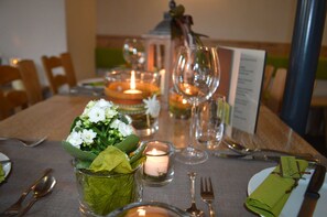 A table set with candles, glassware, and a menu. - Landhotel Zur Bretzel (Babenhausen)