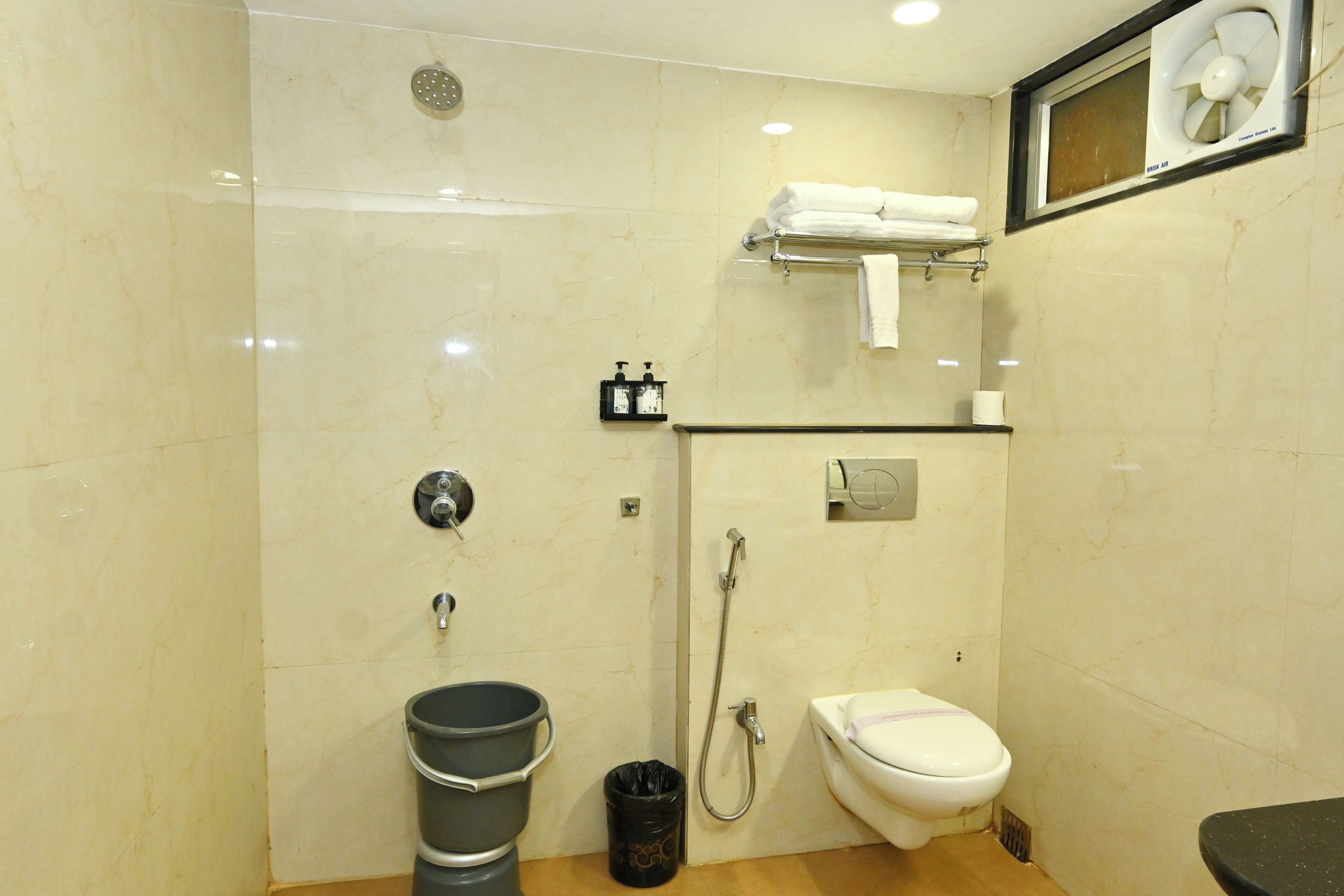 A bathroom with a shower, toilet, and sink.