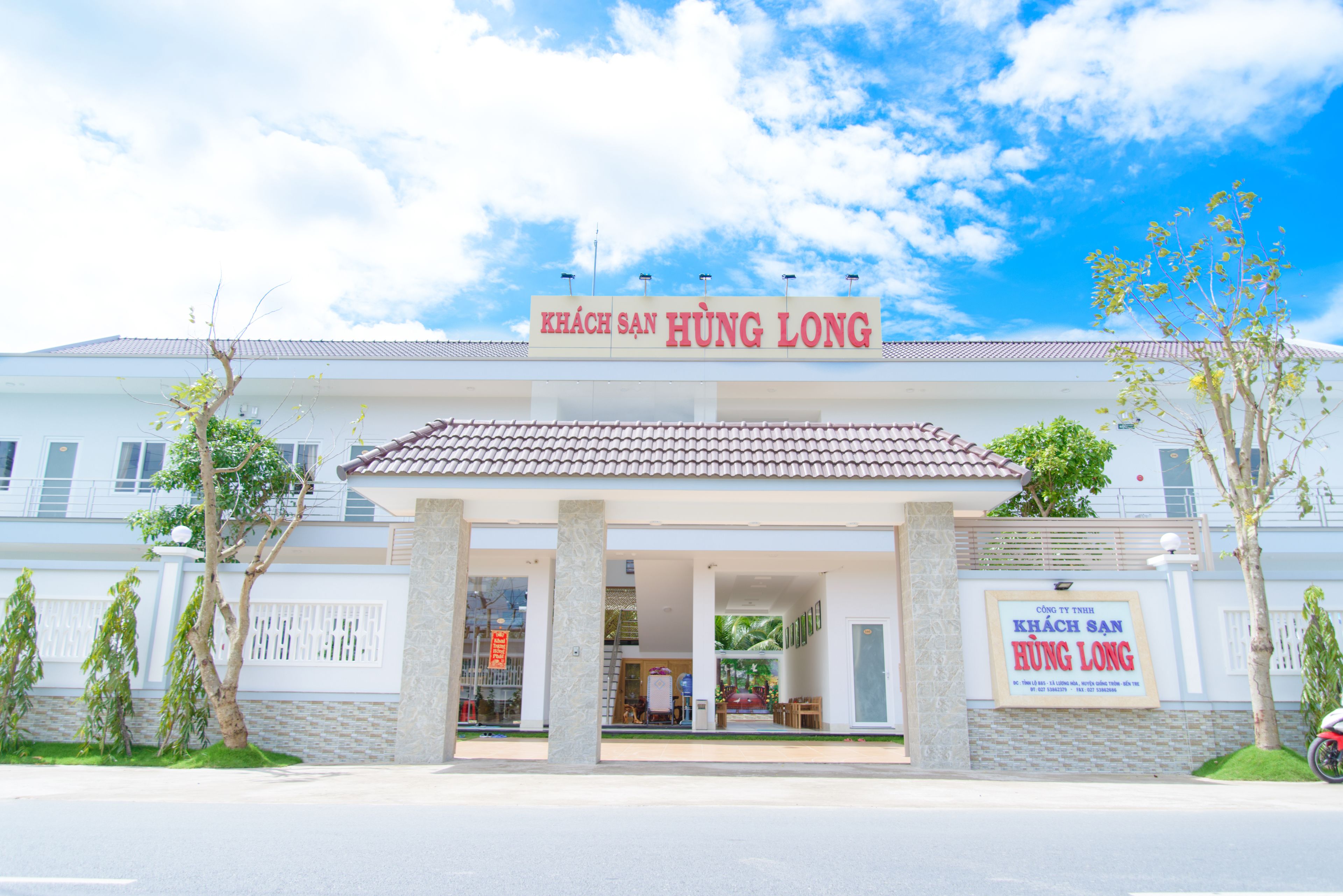 A building with a sign reading "KHÁCH SAN HUNG LONG".