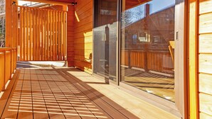 A wooden deck with a glass door leading to a covered area. - Fuyo No Yado (Fujiyoshida)