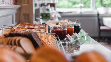A buffet with various food items and condiments.