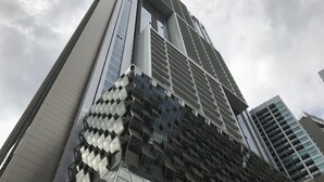 A modern high-rise building with a distinctive geometric facade and reflective glass windows. - LUMA At Platinum Suite (Kuala Lumpur)