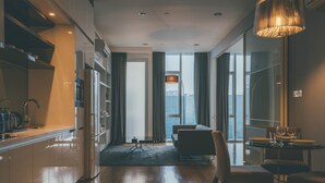 A modern hotel room with a kitchen, a dining area, and a sofa. - LUMA At Platinum Suite (Kuala Lumpur)