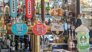 A bar with multiple taps for different types of beer, including Camden Pale Ale and Hells Lager. - Angel & Royal Hotel (Grantham)