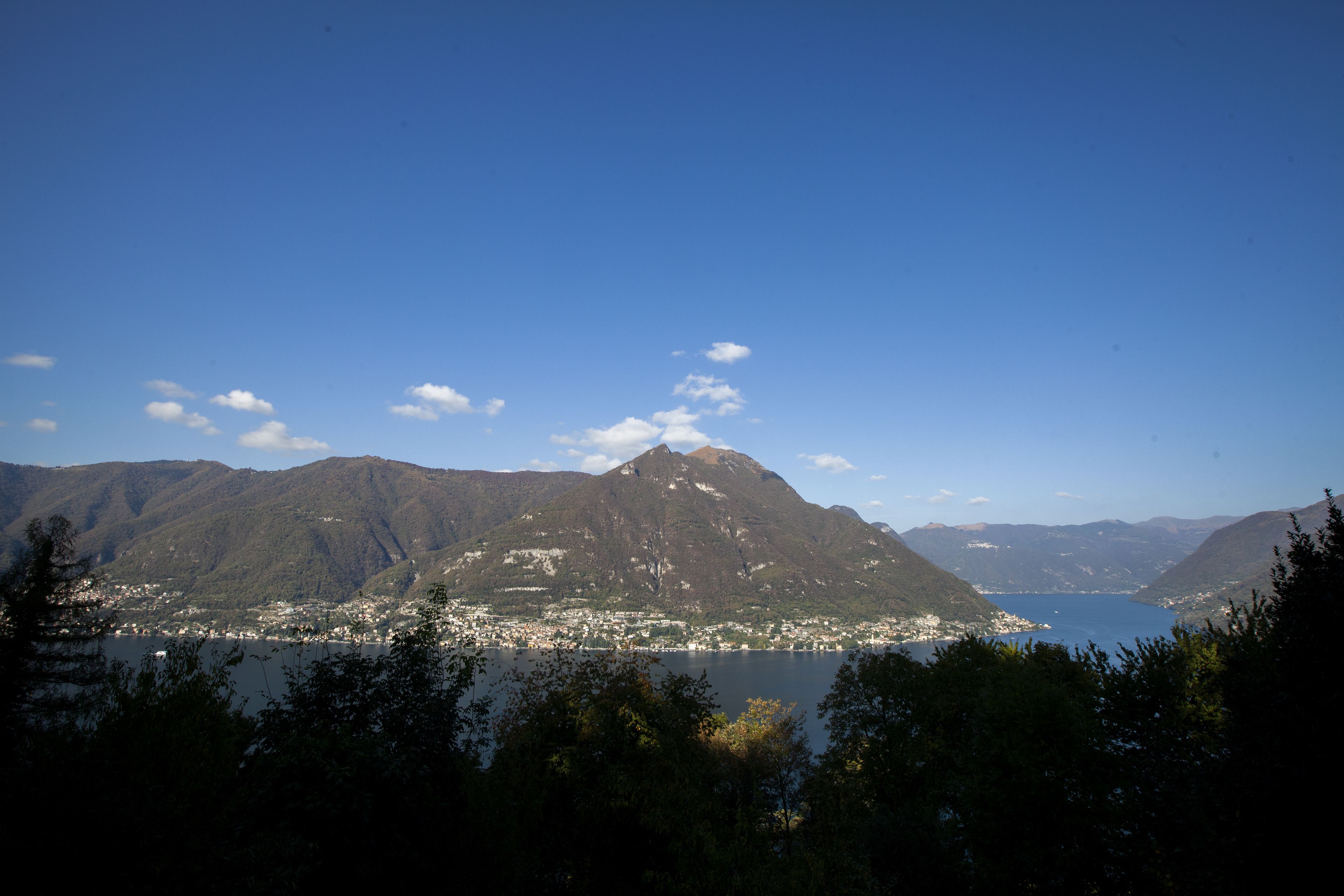 A mountainous landscape with a lake and a town in the valley.