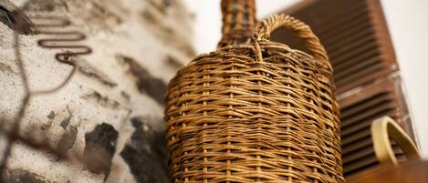 A wicker basket against a textured wall.