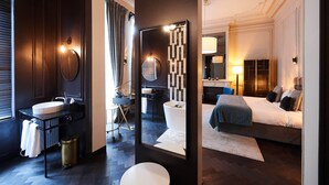 A modern hotel bathroom with a sink, mirror, and toilet. - Harmon House (Brussels)