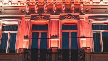 A building with ornate architectural details, including columns, decorative moldings, and a patterned ceiling.
