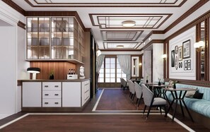 A spacious dining area with a long table, chairs, and a light blue sofa. - Hotel Nautilus (Forte dei Marmi)