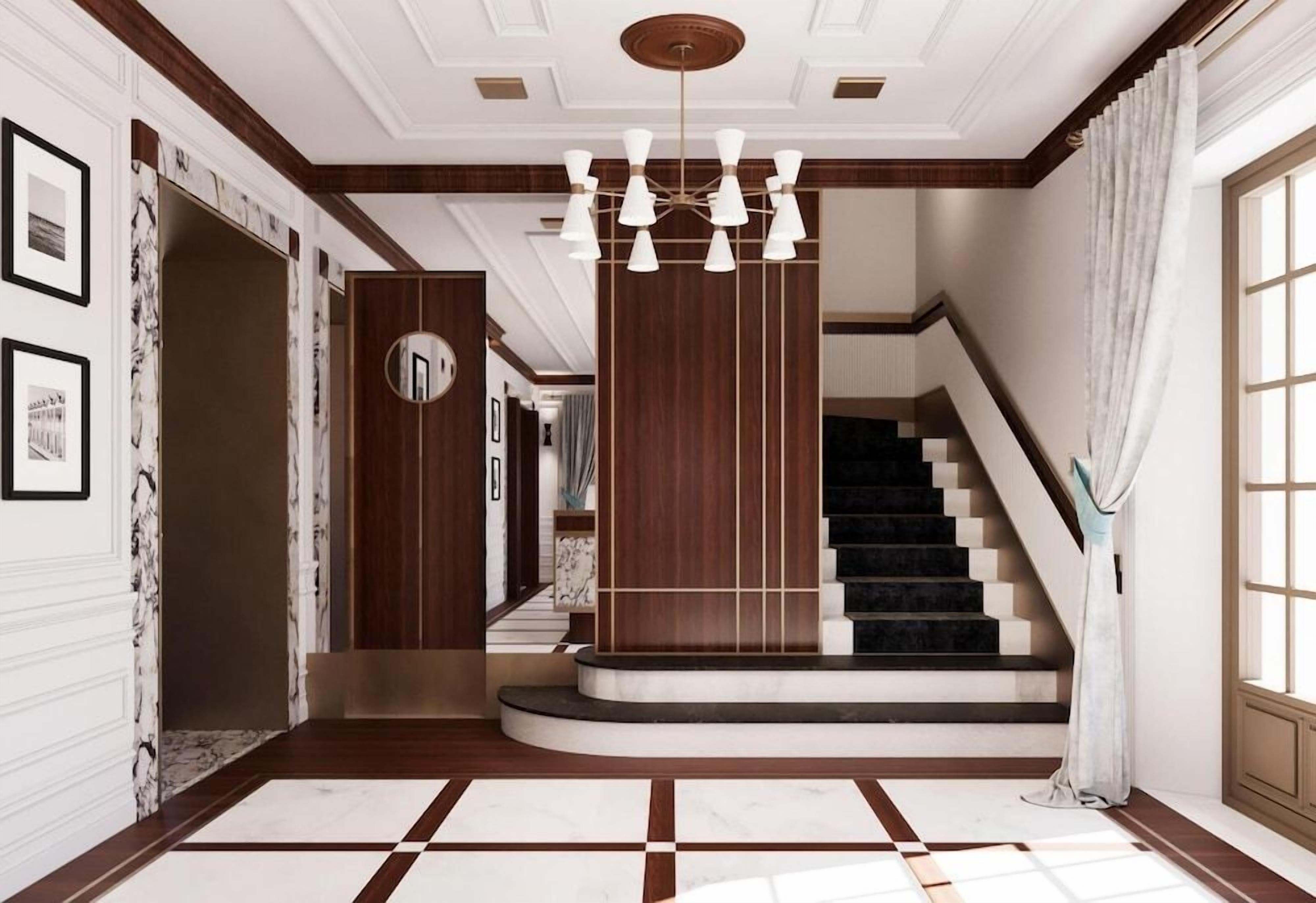 Un amplio pasillo con piso de mármol, una escalera y un moderno candelabro.
