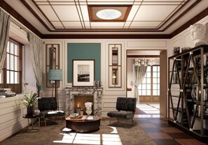 A spacious living room with a fireplace, two armchairs, a coffee table, and a bookshelf. - Hotel Nautilus (Forte dei Marmi)