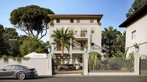 A two-story building with a gated entrance, outdoor seating area, and a sign that reads 'Villa Costanza.' - Hotel Nautilus (Forte dei Marmi)
