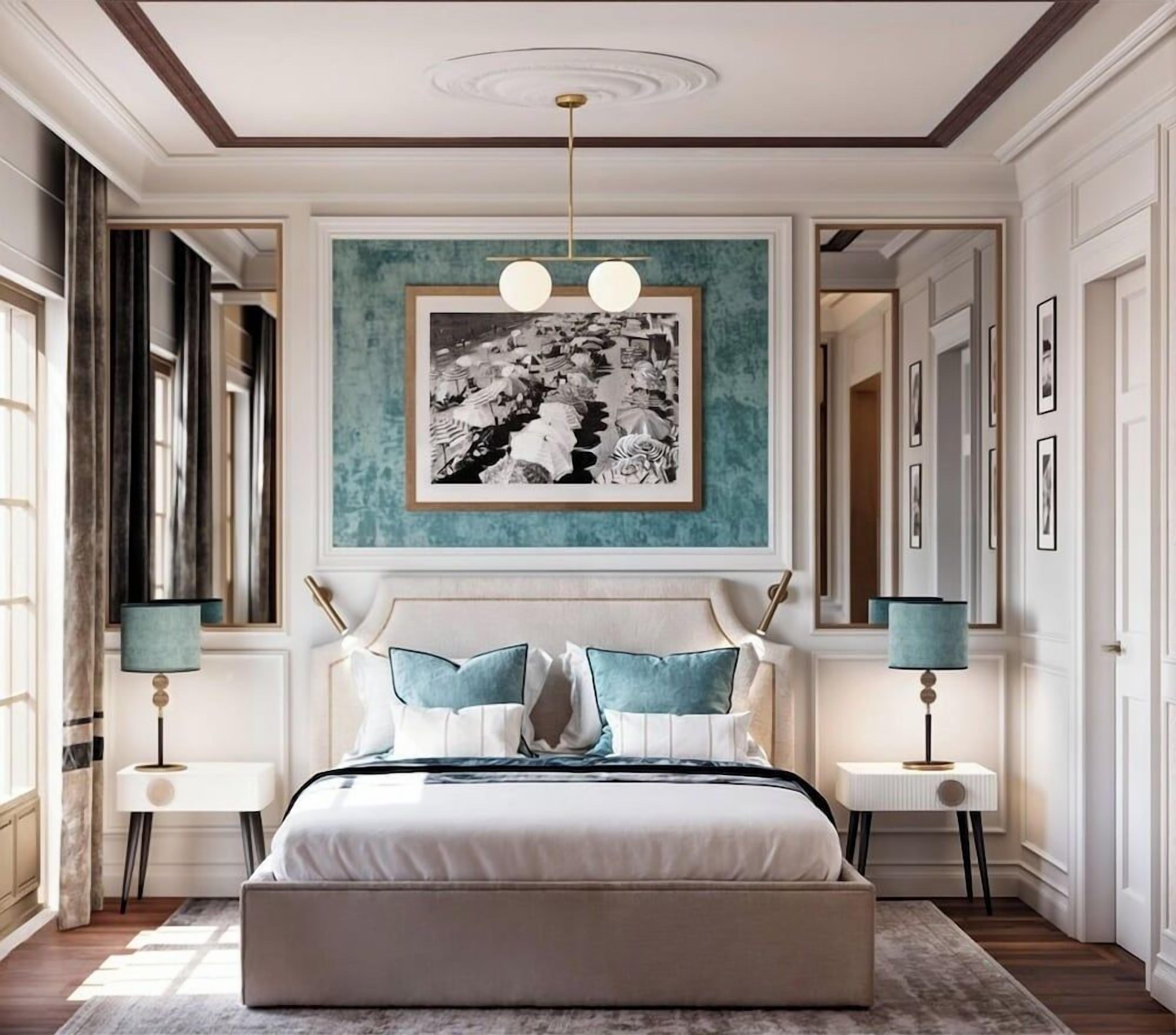 A bedroom with a large bed, two bedside tables, a wall-mounted artwork, and a ceiling light fixture.