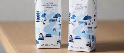 Two cartons of Japan Natural Water Havary's on a wooden surface.