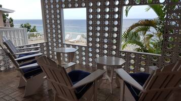 Relax in comfort with ocean views from this serene seating area, featuring a stylish table and chairs.