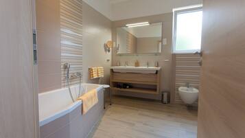 Bathtub, hair dryer, bidet, towels