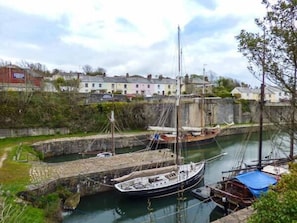Boats moor in the lock system, surrounded by residential buildings.