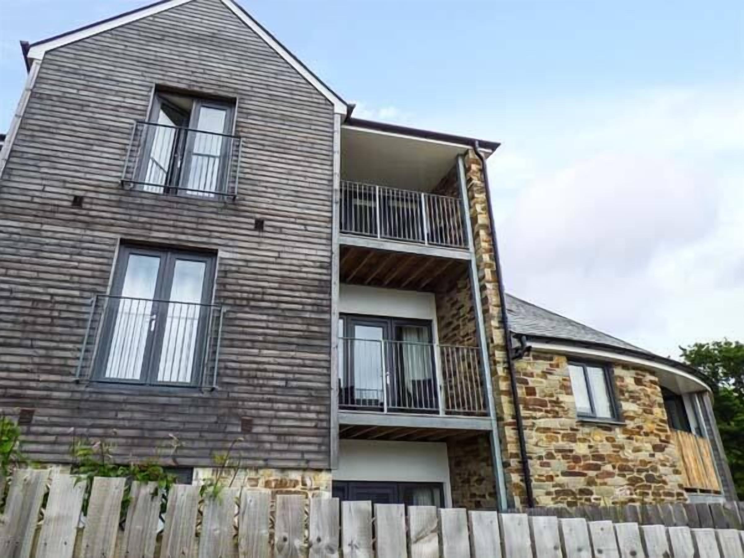 A two-story building with a wooden facade and stone accents.