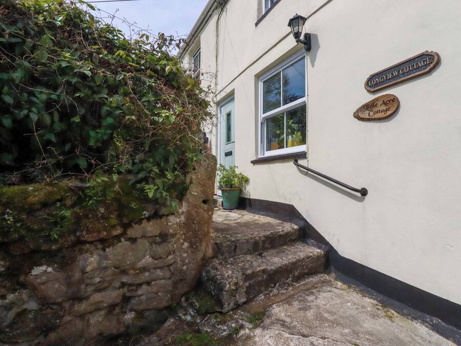 A stone staircase leading to a building with a sign reading 'Longview Cottage.'