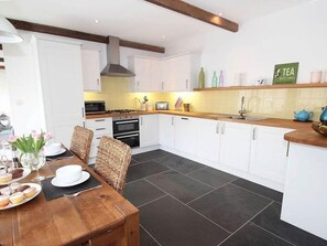Enjoy cooking in this well-equipped kitchen with oven, microwave, and gas stove.