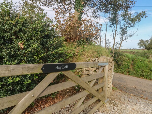 A wooden gate with a sign reading "Hay Loft." - Hay Loft (Camborne)