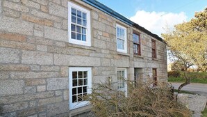 A stone building with multiple windows and a sloped roof. - Halvosso (Penryn)