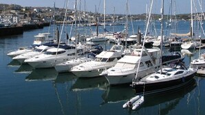 A marina with multiple yachts docked. - Halvosso (Penryn)