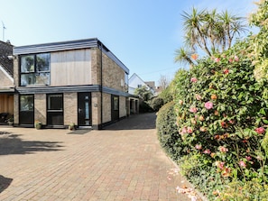 A modern two-story building with large windows and a brick facade. - Little Beach House (St Austell)